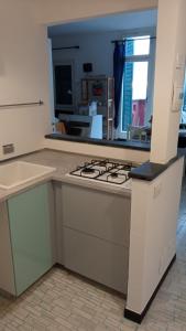 a kitchen with a stove and a counter top at Cinqueterre National Park Sea view in Framura