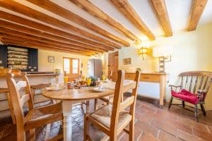 a kitchen and dining room with a wooden table and chairs at Semer Barn in Semer