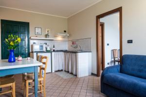 a kitchen and living room with a couch and a table at Agriturismo San Michele di Danio Giovanni in Dolcedo