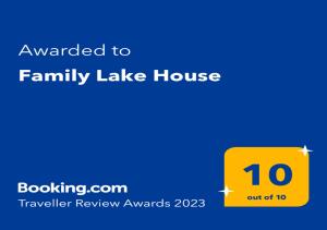 a yellow sign that reads awarded to family lake house at Family Lake House in Mikołajki