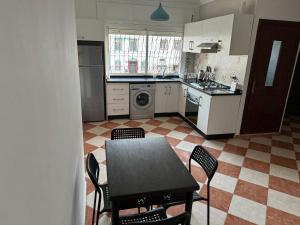 a kitchen with a table and chairs in it at Precioso Apartamento en tetouan in Tetouan