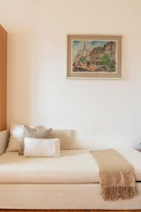 a bedroom with a bed with a picture on the wall at Mavi Flexyrent Apartment in Milan