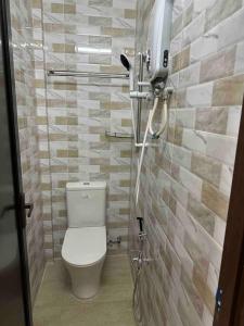 a small bathroom with a toilet and a shower at Homestay Bukit Tinggi Klang in Klang
