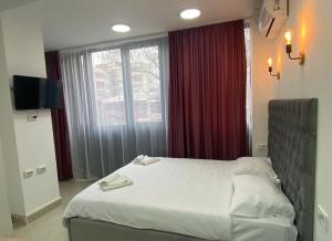 Postel nebo postele na pokoji v ubytování Hotel Fama