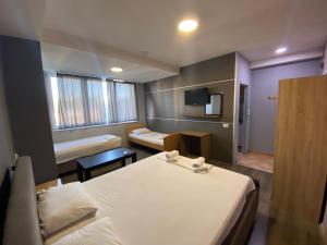 Postel nebo postele na pokoji v ubytování Hotel Fama