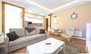a living room with a couch and a table at Apartamentos LA CAÑADA DE OSMA in El Burgo de Osma