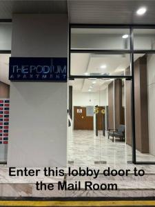 a lobby of a mall room with a sign on the door at The Podium Studio@Amy*Home in Kuching