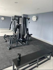a room with a gym with two tread machines at The Podium Studio@Amy*Home in Kuching