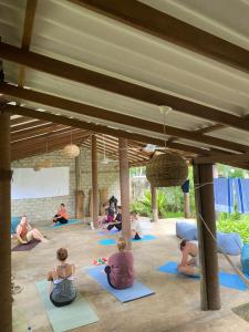 a group of people sitting in a yoga class at The Calm Palm in Hikkaduwa