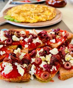 a group of slices of toast with fruit and cheese at Stomio Villague in Filiatra