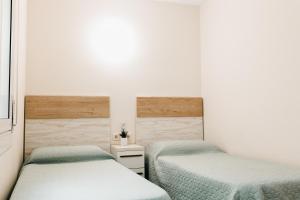Postel nebo postele na pokoji v ubytování Hauzify I Apartament Arroyo