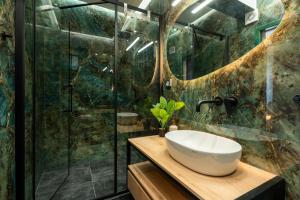 a bathroom with a sink and a shower at Syntagma Bliss: Athens Hub in Athens +8 photos