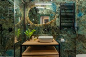 a bathroom with a sink and a mirror at Syntagma Bliss: Athens Hub in Athens