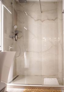 a shower with a glass door in a bathroom at Nisa Kub Residence in Hărman