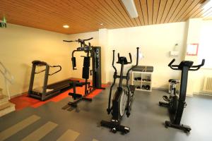 a gym with several treadmills and exercise bikes at Apartment "Schlupfwinkel" im Haus Feldbergblick, Lenzkirch, Innenpool, Sauna in Lenzkirch