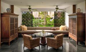 a living room with a couch and a table and chairs at InterContinental Bali Sanur Resort by IHG in Sanur