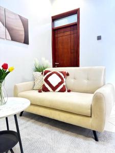 a living room with a couch and a table at The Croft Homes -Kampala Buwatte in Wakiso
