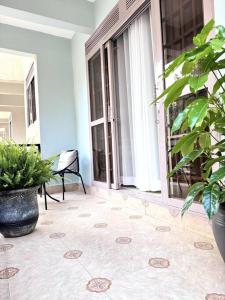 a room with a patio with plants and a window at The Croft Homes -Kampala Buwatte in Wakiso