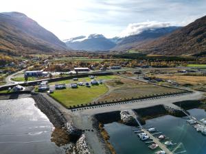an aerial view of a marina with a bridge and mountains at Løkvollstranda camping As in Samuelsberg