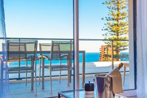 a balcony with chairs and a view of the ocean at Luxury apartment - Sea View - Private parking in Beausoleil