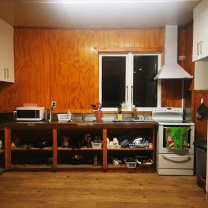 a kitchen with a sink and a microwave at Bluewater Lodge in Napier