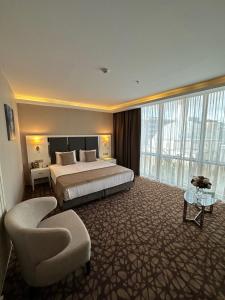 A bed or beds in a room at The Conforium Hotel Van