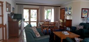 a living room with couches and a coffee table at Braeview Guest House in Hermanus