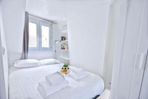 two white beds in a white room with a window at Promo! near The Pantheon - Latin Quarter! in Paris