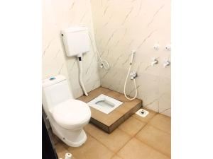 a bathroom with a toilet with a box in the floor at Second Home Guest House Near Agha, Khan Airport in Karachi