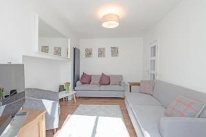 a living room with a couch and a table at Bakers House - 4 Bedrooms - Parking for 3 cars - Dogs welcome in Wells next the Sea