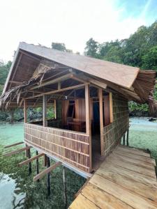 Junior Homestay في Kri: منزل صغير على رصيف على الماء