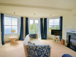 een woonkamer met een bank en een open haard bij 4 St Michaels House in Lyme Regis