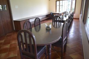 a dining room with a long table and chairs at River Valley Resort in Masinagudi