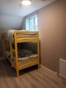 a bunk bed in a room with a window at Beautiful House in Killarney county kerry in Coolcorcoran Bridge