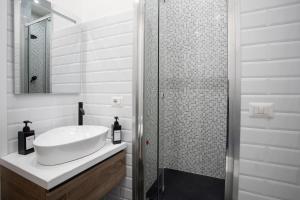 a white bathroom with a sink and a shower at 2 Passi Da in Rome +44 photos