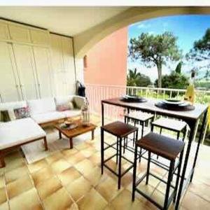 a living room with a table and chairs at Studio Apartment - Domaine du Golf Resort in Roquebrune-sur-Argens
