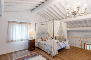 a bedroom with a canopy bed and a chandelier at Agriturismo Poggio Nardini in Montelupo Fiorentino +144 photos
