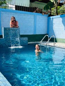 a woman and a child in a swimming pool at Villa Eco Green Airport in Katunayake