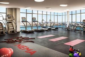 a gym with treadmills and a swimming pool at Seaport studio w fitness close to shops dining BOS-990 in Boston