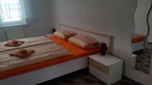 a small bedroom with a bed with two pillows at Ferienhaus Benneckenstein in Benneckenstein