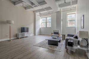 an empty living room with a couch and a tv at Central Square 2br w fitness close to dining BOS-993 in Cambridge