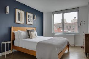 a bedroom with a large bed and a window at E Village 1br w gym wd doorman nr Union Sq NYC-278 in New York