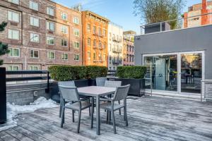 a patio with a table and chairs on a balcony at E Village 1br w gym wd doorman nr Union Sq NYC-278 in New York