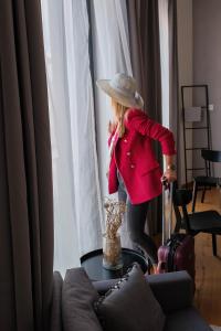 a little girl standing in a room with a suitcase at Piano apartments - LICITY in Žilina