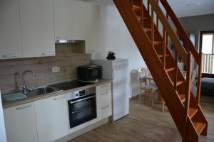 a kitchen with a sink and a microwave at Apartmaji Kobal in Zoll
