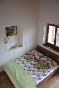 a bedroom with a large bed with colorful pillows at Apartmaji Kobal in Zoll