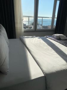 a white bed in a room with a window at Timex Suites in Istanbul