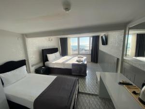 Säng eller sängar i ett rum på Timex Suites