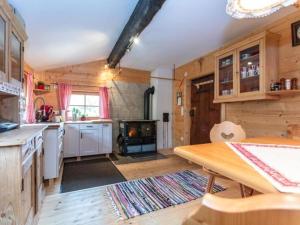 a kitchen with a table and a stove in it at Almhütte Bairau Kaser in Lofer