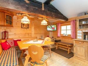 a living room with a table and a television in a cabin at Almhütte Bairau Kaser in Lofer